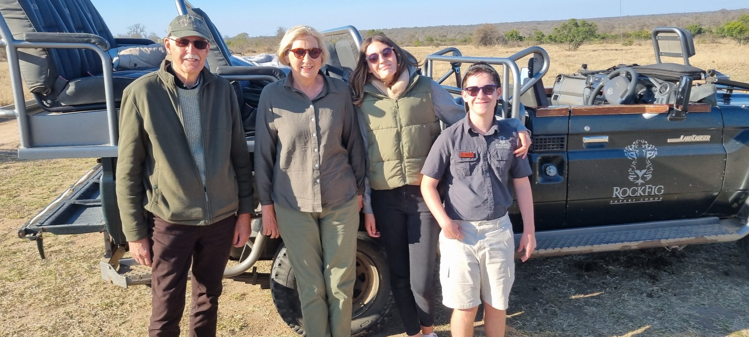 The Hillborn family standing beside a Rockfig safari vehicle in the bush