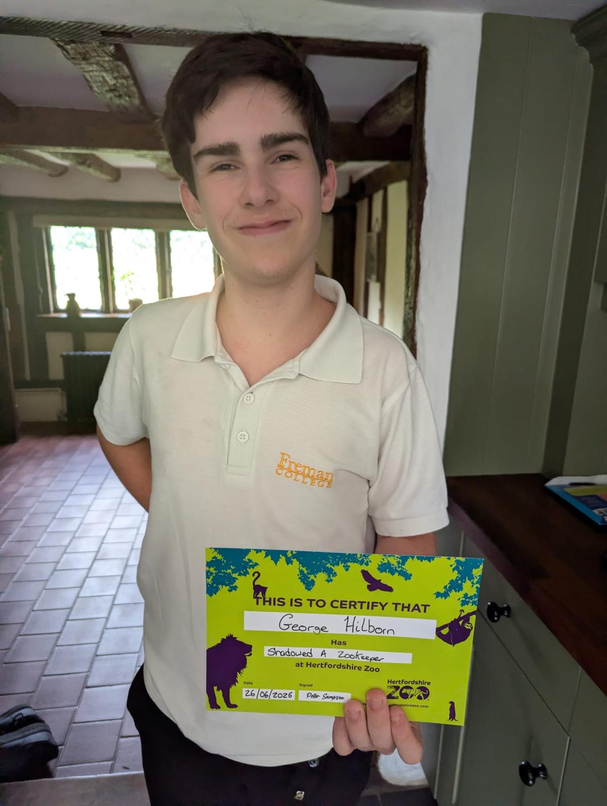 George holding his Hertfordshire Zoo certificate for shadowing a zookeeper