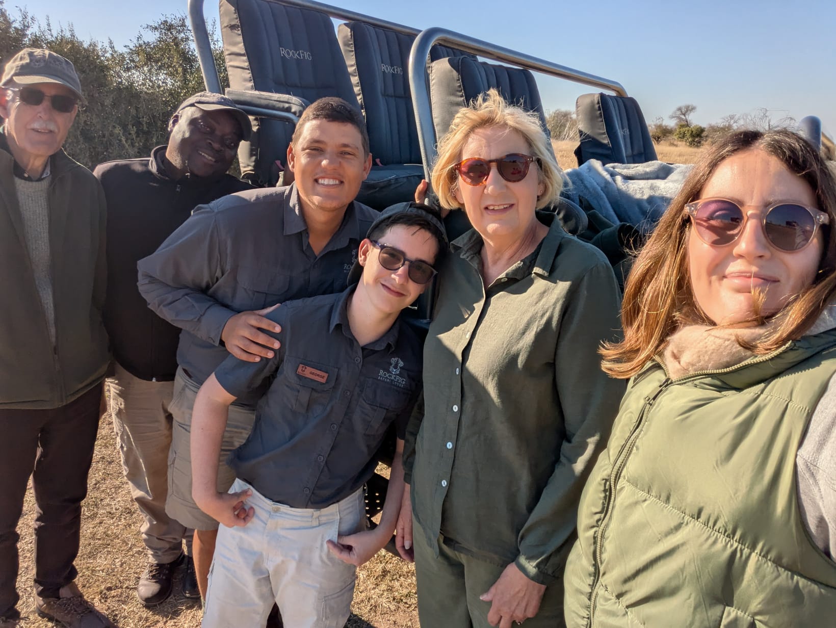 The Hillborn family with Karel and tracker Rennico gathered beside the safari vehicle